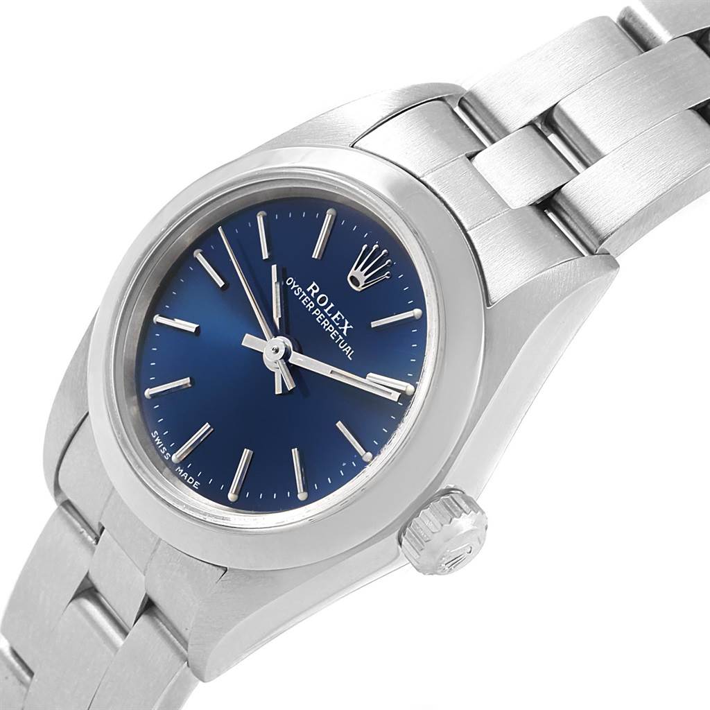 This image shows a close-up angled view of the dial, crown, and part of the bracelet of a Rolex Oyster Perpetual 76080 Women's Stainless Steel Blue Dial 76080 Women's Stainless Steel Blue Dial watch.