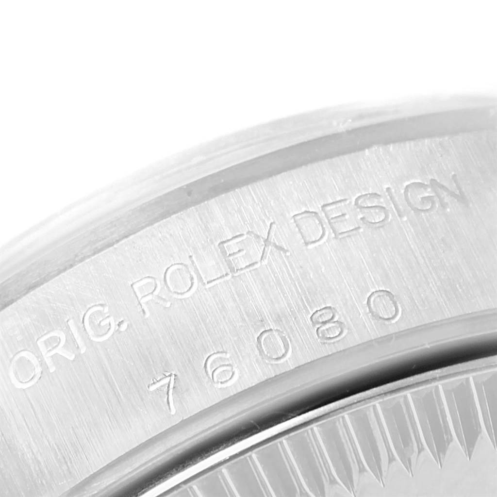This image shows a close-up of the case back of a Rolex Oyster Perpetual 76080 Women's Stainless Steel Blue Dial 76080 Women's Stainless Steel Blue Dial watch displaying the engraved model number.