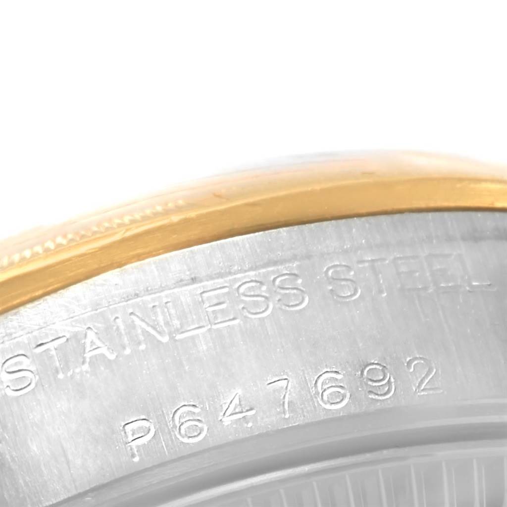This close-up image features the stainless steel caseback edge of a Rolex Oyster Perpetual 76243 Women's Steel and Gold (two tone) Champagne Dial 76243 Women's Steel and Gold (two tone) Champagne Dial watch.