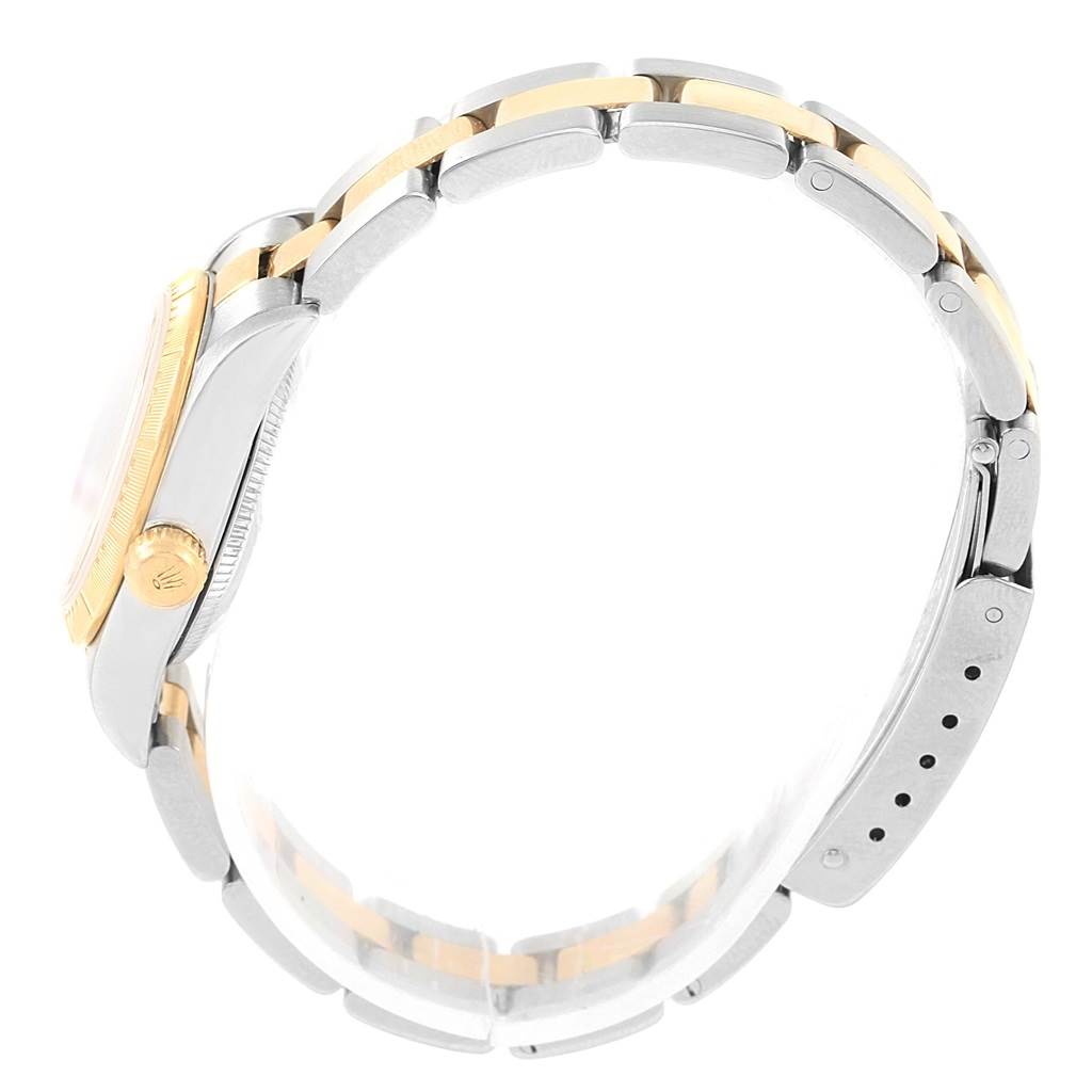 The image shows a side profile of a Rolex Oyster Perpetual 76243 Women's Steel and Gold (two tone) Champagne Dial 76243 Women's Steel and Gold (two tone) Champagne Dial watch, highlighting its two-tone bracelet and crown.