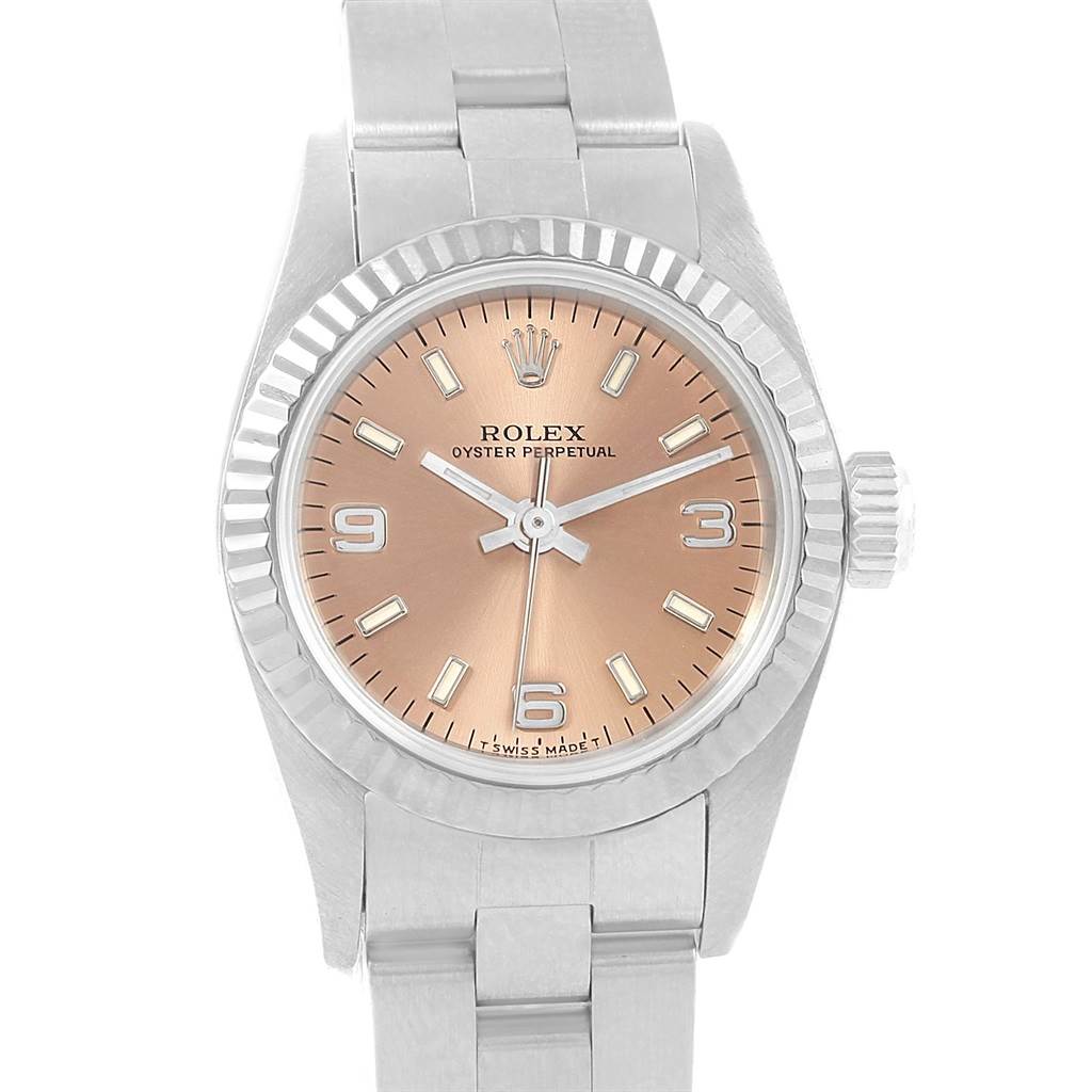 The image shows a close-up view of the Rolex Oyster Perpetual 67194 Women's Stainless Steel Pink Dial 67194 Women's Stainless Steel Pink Dial watch, highlighting its dial, bezel, and bracelet.