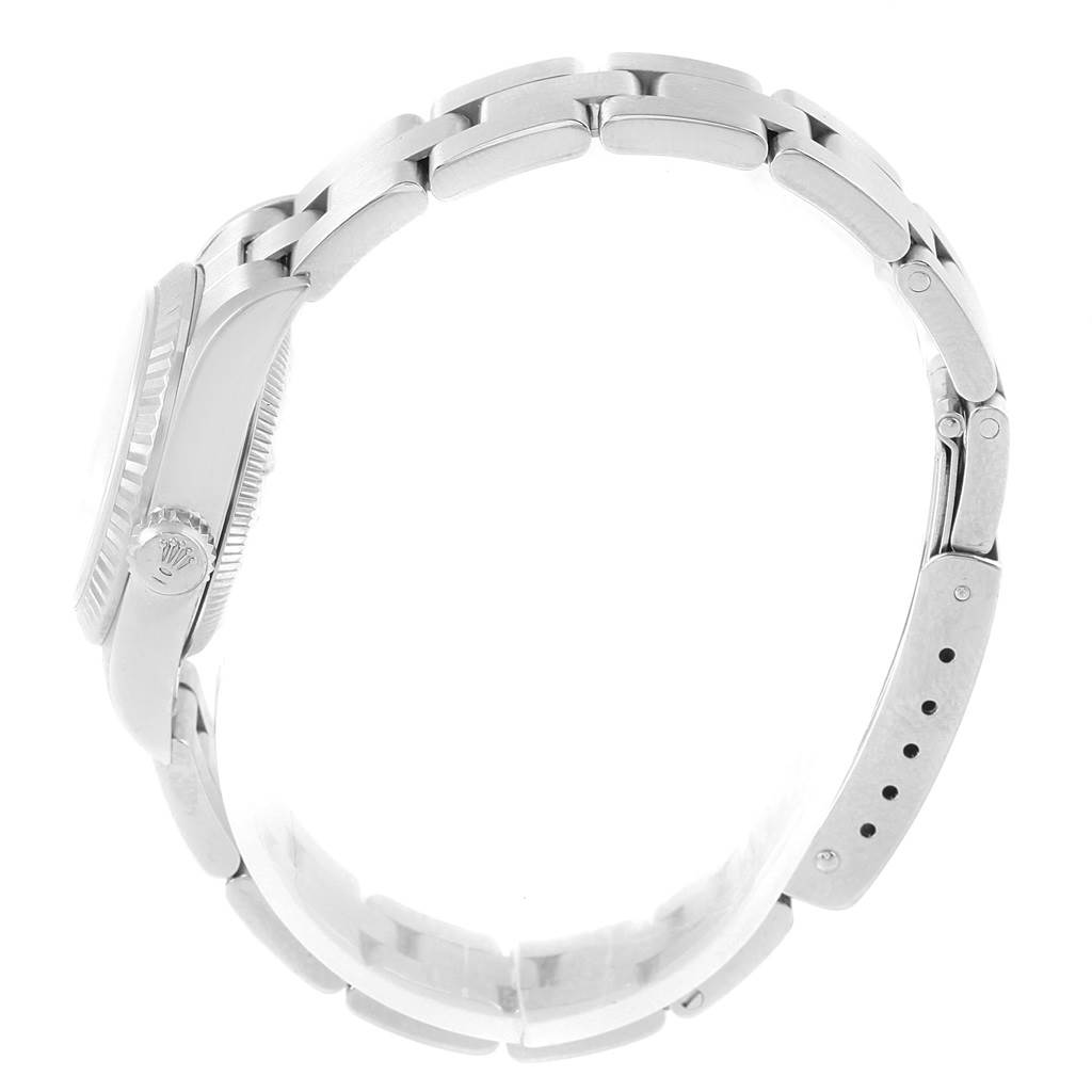 The Rolex Oyster Perpetual 67194 Women's Stainless Steel Pink Dial 67194 Women's Stainless Steel Pink Dial watch is shown from a side angle, focusing on the bracelet and the crown.