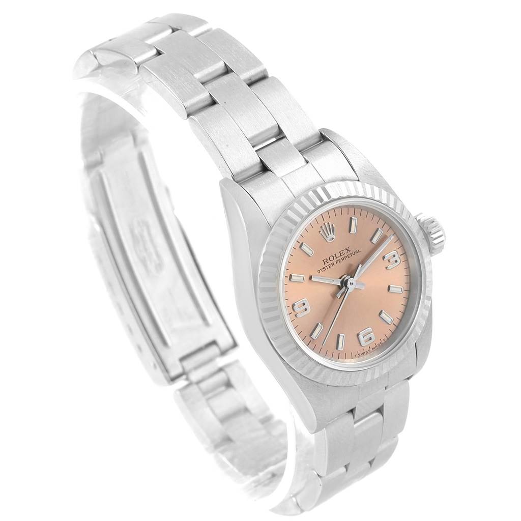 The image shows a side angle of a Rolex Oyster Perpetual 67194 Women's Stainless Steel Pink Dial 67194 Women's Stainless Steel Pink Dial watch displaying its face, bezel, crown, and bracelet.