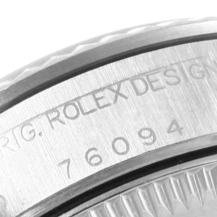 This image shows a close-up of the side engraving and bezel edge of a Rolex Oyster Perpetual 76094 Women's Stainless Steel Black Dial 76094 Women's Stainless Steel Black Dial watch.