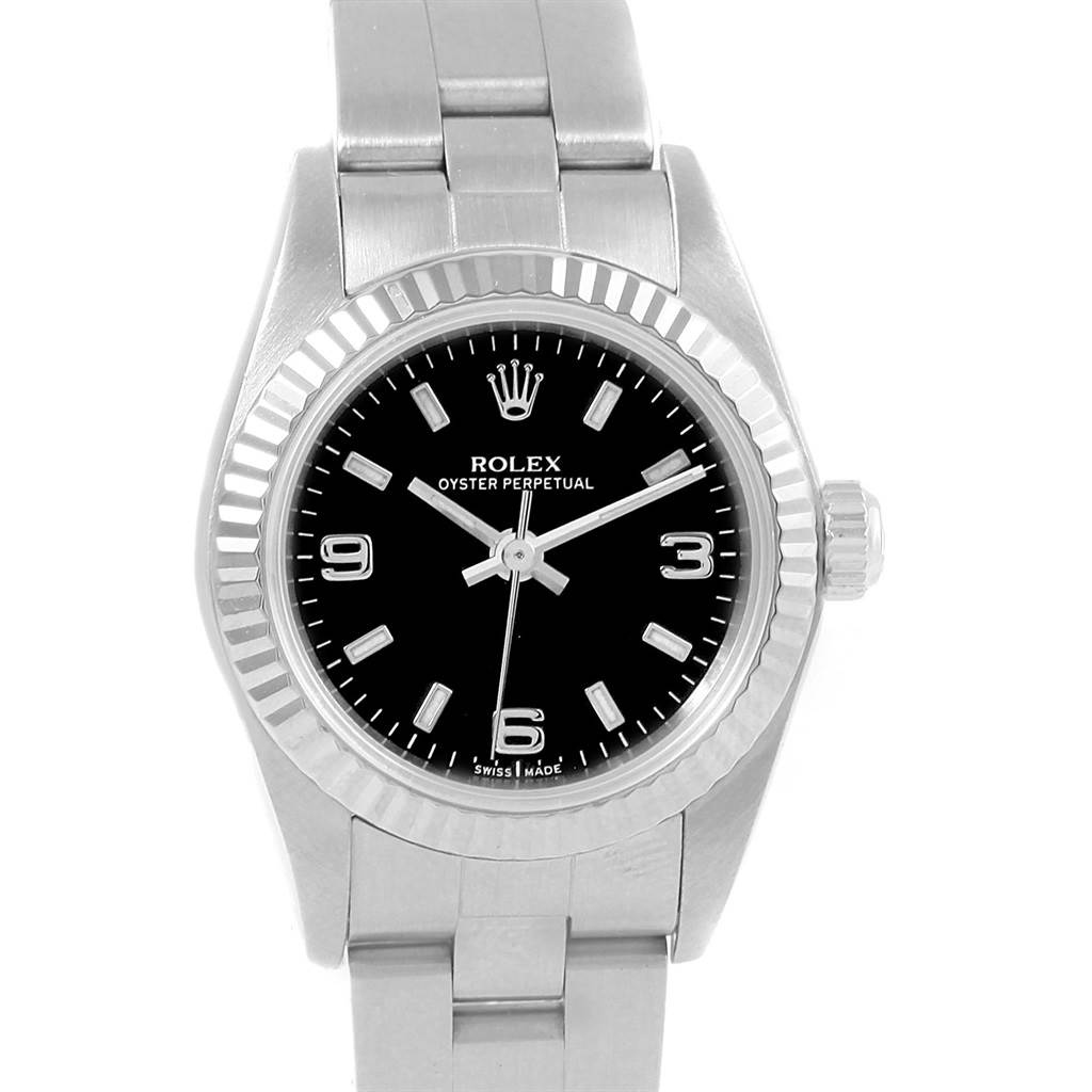 The image shows a front view of a Rolex Oyster Perpetual 76094 Women's Stainless Steel Black Dial 76094 Women's Stainless Steel Black Dial watch, displaying the face, bezel, crown, and part of the bracelet.