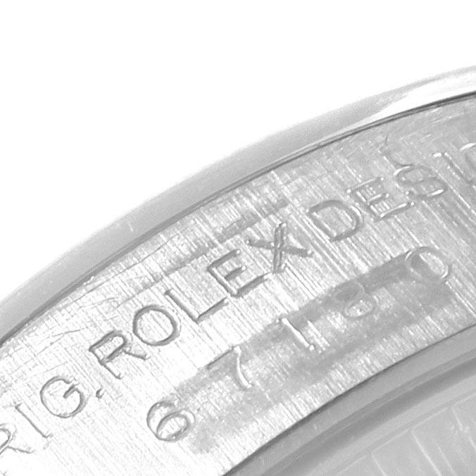 This image shows a close-up of the engraved inner bezel or rehaut on a Rolex Oyster Perpetual 67180 Women
s Stainless Steel Pink Dial 67180 Women
s Stainless Steel Pink Dial watch.