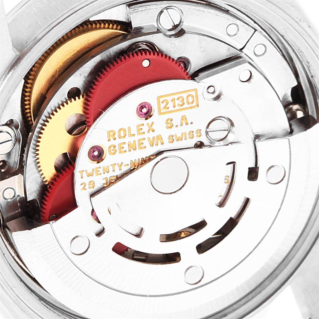 The image shows the internal mechanism of a Rolex Oyster Perpetual 67180 Women
s Stainless Steel Pink Dial 67180 Women
s Stainless Steel Pink Dial watch, highlighting its gears and movement components.