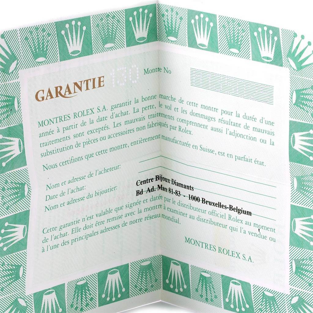 The image shows a close-up of a warranty certificate for a Rolex Oyster Perpetual 67180 Women
s Stainless Steel Pink Dial 67180 Women
s Stainless Steel Pink Dial watch, with green detailing and text fields.