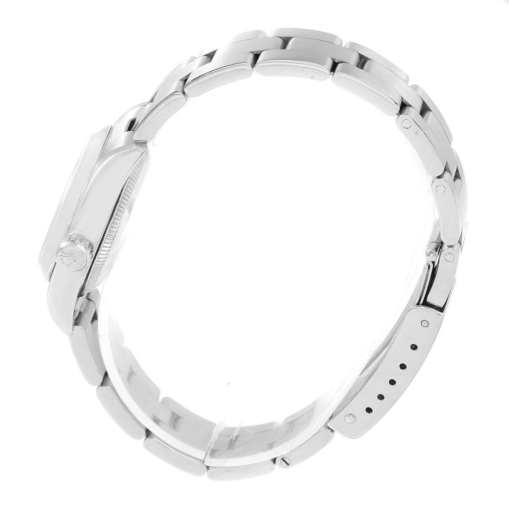 The image shows the side view of a Rolex Oyster Perpetual 67180 Women
s Stainless Steel Pink Dial 67180 Women
s Stainless Steel Pink Dial watch, featuring its case, crown, and bracelet.