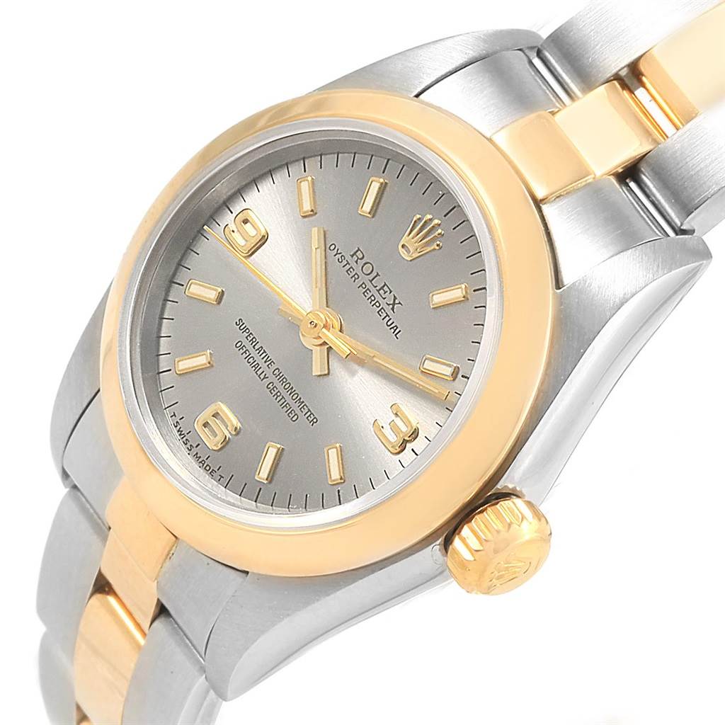 The Rolex Oyster Perpetual 67183 Women's Steel and Gold (two tone) Grey Dial 67183 Women's Steel and Gold (two tone) Grey Dial watch is shown at an oblique angle with a clear view of the dial, bezel, and part of the bracelet.
