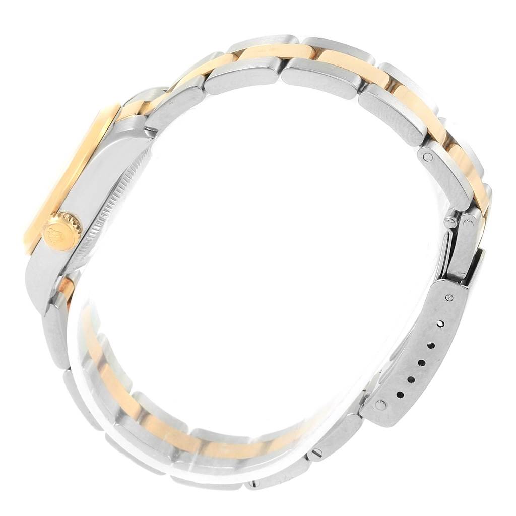 The side angle of the Rolex Oyster Perpetual 67183 Women's Steel and Gold (two tone) Grey Dial 67183 Women's Steel and Gold (two tone) Grey Dial watch shows the bracelet, clasp, crown, and part of the case.