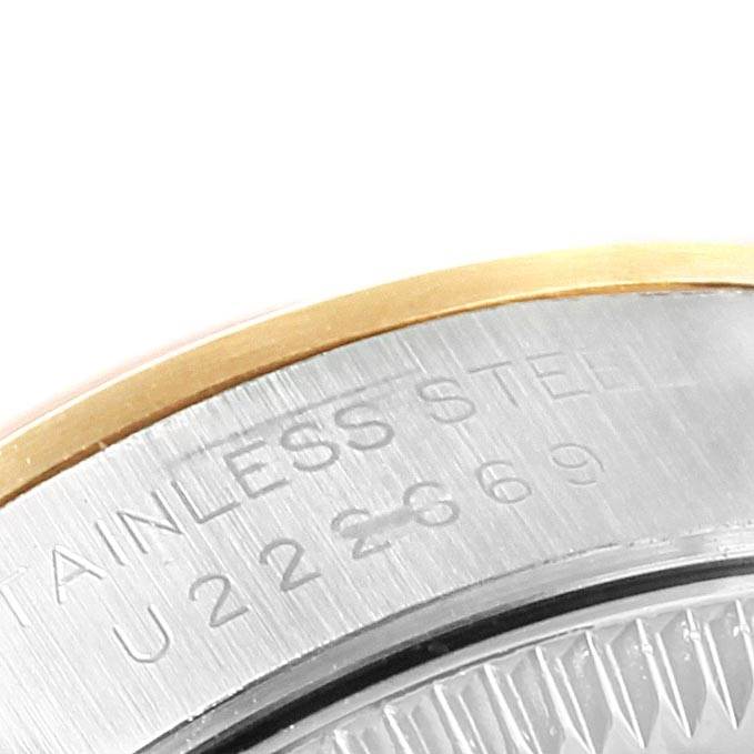 The image shows a close-up of the case back and part of the bezel of a Rolex Oyster Perpetual 67183 Women's Steel and Gold (two tone) Grey Dial 67183 Women's Steel and Gold (two tone) Grey Dial watch, highlighting the stainless steel text.
