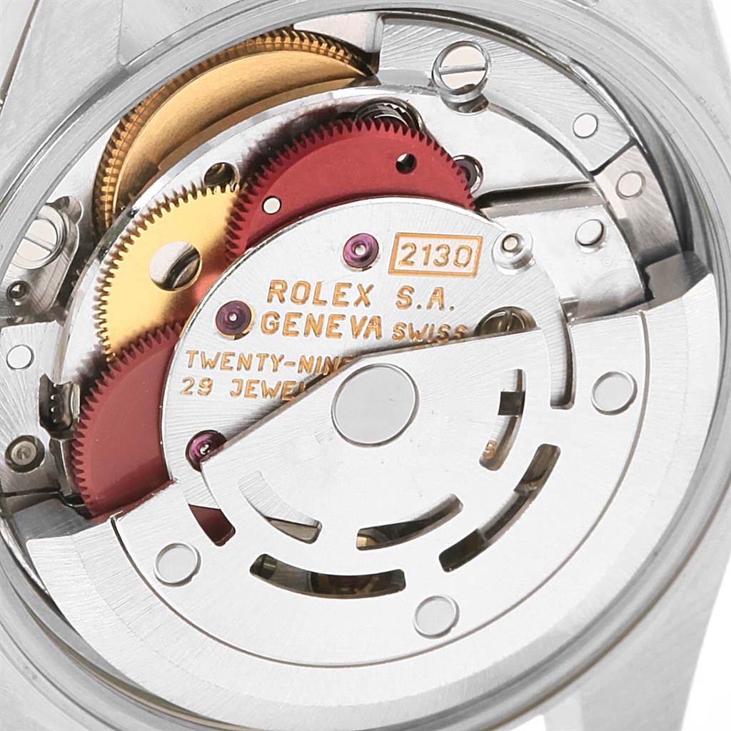 This image shows the internal mechanism of a Rolex Oyster Perpetual 67183 Women's Steel and Gold (two tone) Grey Dial 67183 Women's Steel and Gold (two tone) Grey Dial watch, focusing on the gears and movement parts.