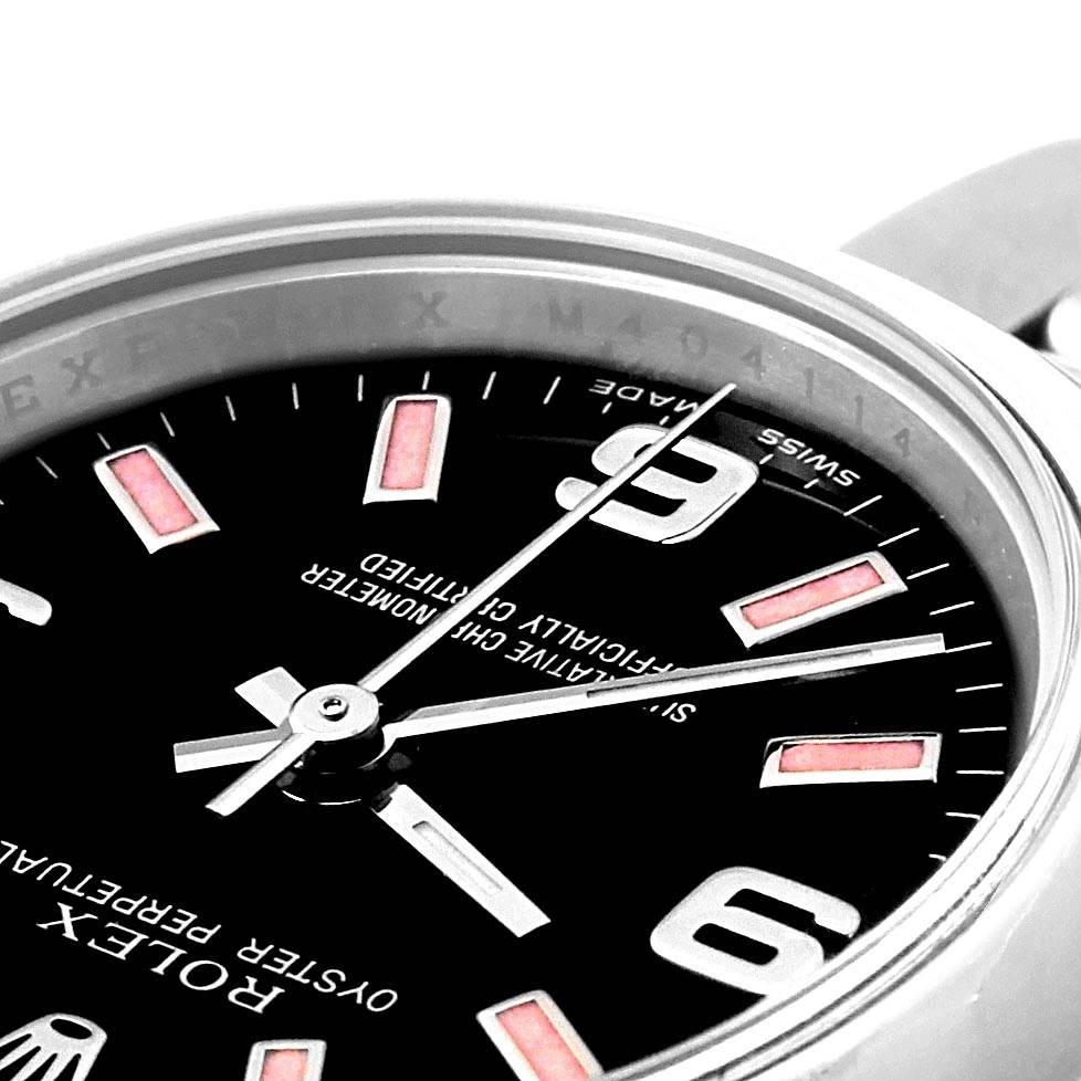 This close-up image of a Rolex Oyster Perpetual 176200 Women's Stainless Steel Black Dial 176200 Women's Stainless Steel Black Dial watch shows part of the dial, hour markers, and partial bezel.