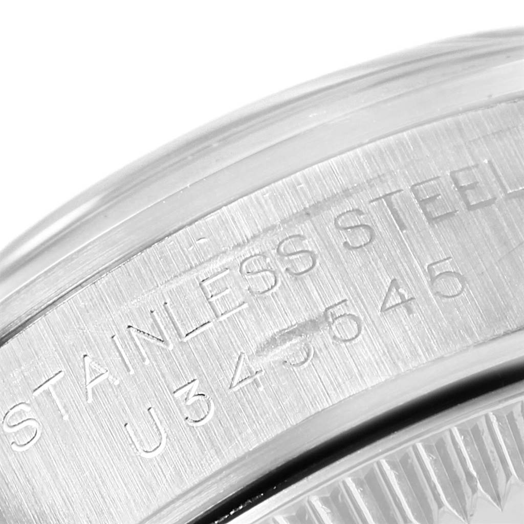 This close-up shows the engraved stainless steel case of the Rolex Oyster Perpetual 67180 Women
s Stainless Steel Pink Dial 67180 Women
s Stainless Steel Pink Dial watch.