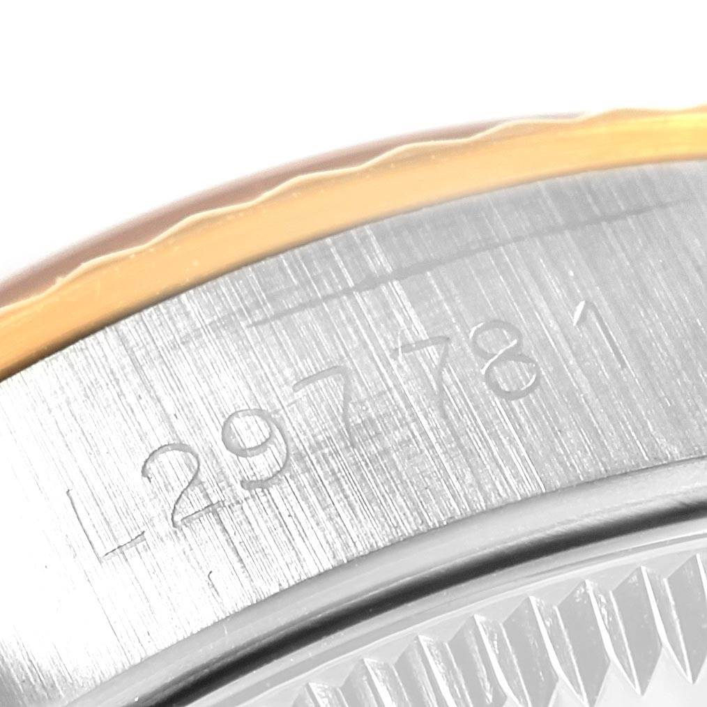 The image shows a close-up of the serial number engraved on the case of a Rolex Oyster Perpetual 67193 Women's Steel and Gold (two tone) Champagne Dial 67193 Women's Steel and Gold (two tone) Champagne Dial watch.