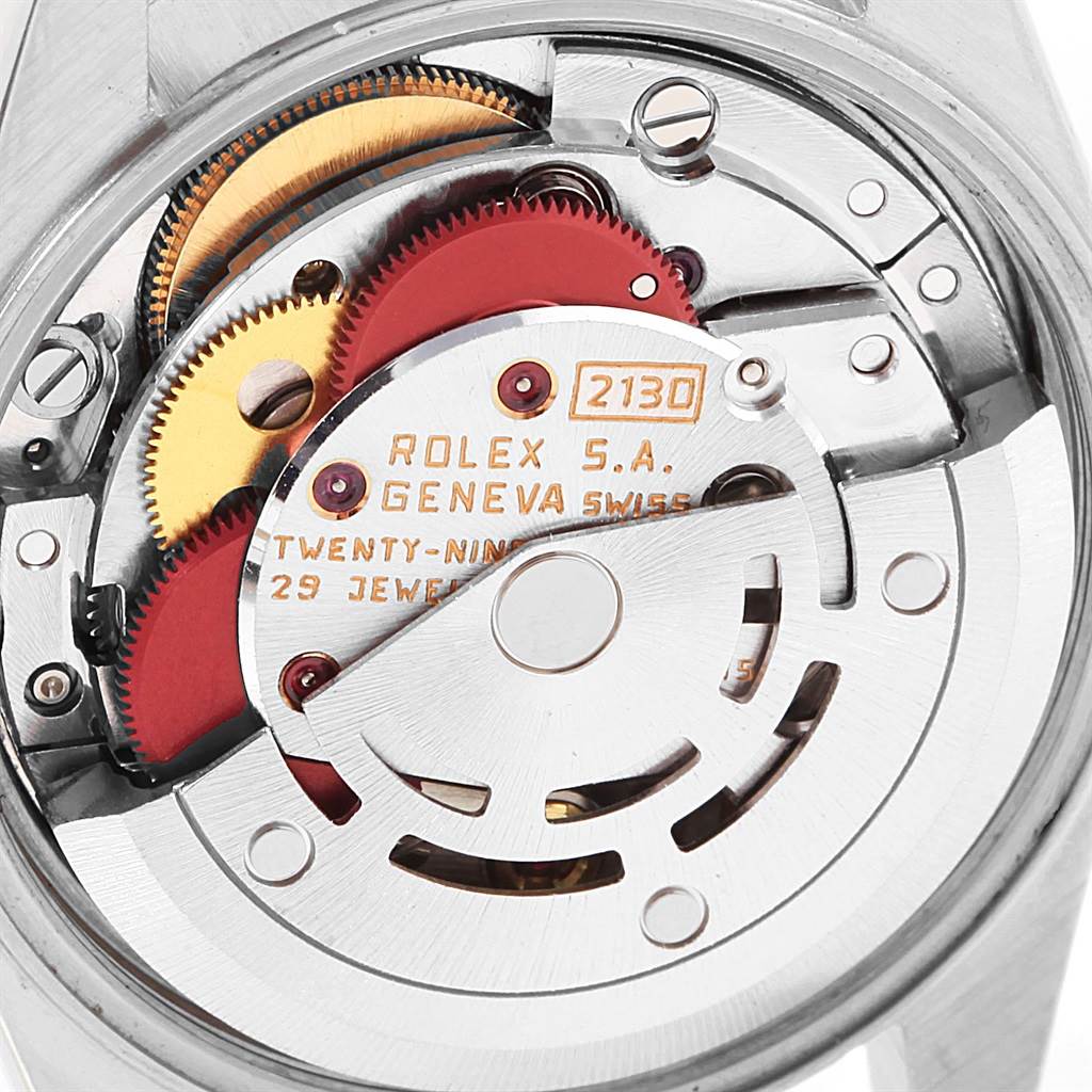 This image shows the internal mechanism of a Rolex Oyster Perpetual 67193 Women's Steel and Gold (two tone) Champagne Dial 67193 Women's Steel and Gold (two tone) Champagne Dial watch, highlighting the intricate gears and movement parts.