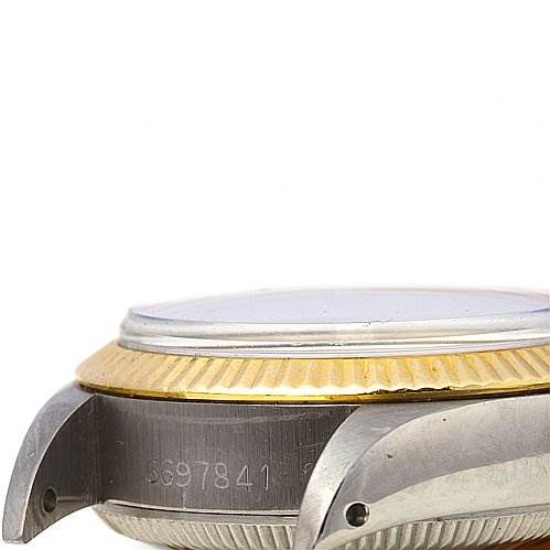 The image shows a side view of a Rolex Oyster Perpetual 6719 Women's Stainless Steel Silver Dial 6719 Women's Stainless Steel Silver Dial watch, focusing on the case and serial number.