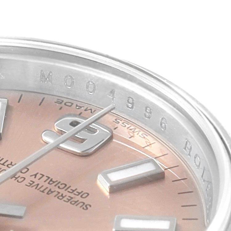This close-up image shows the dial and part of the bezel of a Rolex Oyster Perpetual 176200 Women
s Stainless Steel Pink Dial 176200 Women
s Stainless Steel Pink Dial watch.