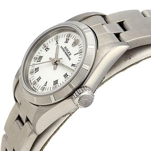 This image shows a Rolex Oyster Perpetual 67230 Women's Stainless Steel White Dial 67230 Women's Stainless Steel White Dial watch from a side angle, highlighting the bezel, crown, and part of the bracelet.