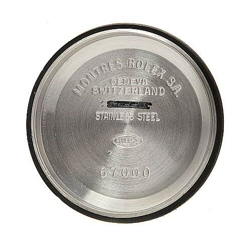 This image shows the inside case back of a Rolex Oyster Perpetual 67230 Women's Stainless Steel White Dial 67230 Women's Stainless Steel White Dial watch, with various inscriptions including the brand, model number, and material.