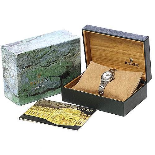 The image shows a Rolex Oyster Perpetual 67230 Women's Stainless Steel White Dial 67230 Women's Stainless Steel White Dial watch in its open box, with an outer box and booklet also visible.