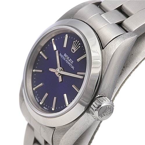 The image shows a side angle of a Rolex Oyster Perpetual 67180 Women's Stainless Steel Blue Dial 67180 Women's Stainless Steel Blue Dial watch, highlighting the crown, case, bracelet, and partial face with the brand logo.