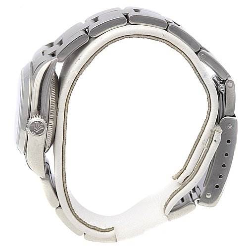 This side view of the Rolex Oyster Perpetual 67180 Women's Stainless Steel Blue Dial 67180 Women's Stainless Steel Blue Dial watch shows the bracelet, clasp, and the watch crown with the Rolex logo.