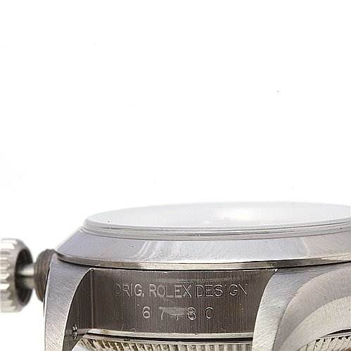 The image shows a close-up side view of the crown and part of the case of a Rolex Oyster Perpetual 67180 Women's Stainless Steel Black Dial 67180 Women's Stainless Steel Black Dial watch.