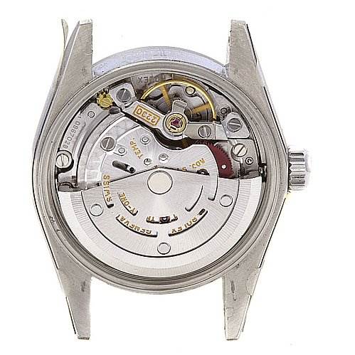 The image shows the back view of the Oyster Perpetual Rolex watch, revealing its internal mechanical movement.