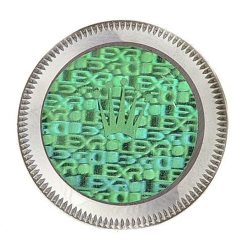 This image shows a close-up of the crown logo on the caseback of a Rolex Oyster Perpetual 76080 Women's Stainless Steel Silver Dial 76080 Women's Stainless Steel Silver Dial watch.