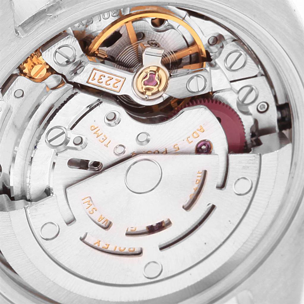 The image shows the intricate movement mechanism of the Rolex Oyster Perpetual 176200 Women
s Stainless Steel Black Dial 176200 Women
s Stainless Steel Black Dial watch from a close-up angle.