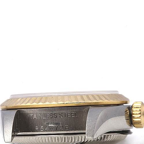 Side view of a Rolex Oyster Perpetual 76193 Women's Stainless Steel Silver Dial 76193 Women's Stainless Steel Silver Dial watch case, showcasing the stainless steel body, gold bezel, and winding crown.