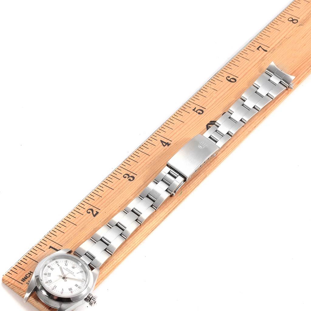 The image shows a Rolex Oyster Perpetual 76080 Women's Stainless Steel White Dial 76080 Women's Stainless Steel White Dial watch laid flat alongside a ruler, displaying the watch face, band, and clasp.