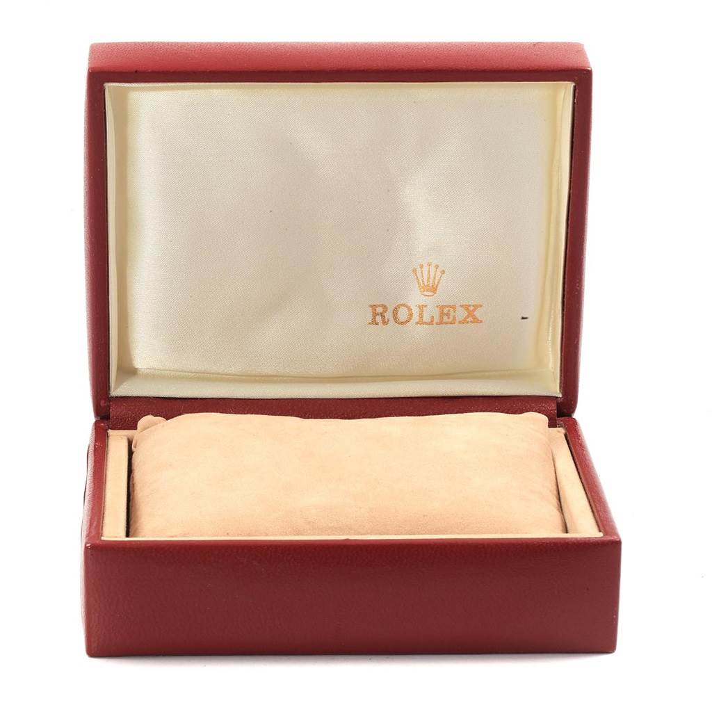The image shows an open Rolex watch box with a cushion, angled from the front.