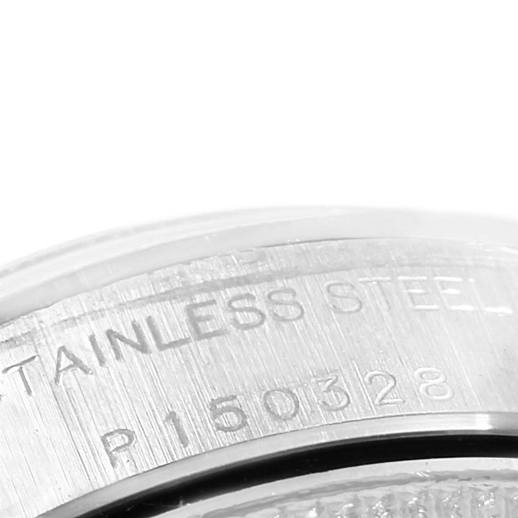 This close-up image of a Rolex Oyster Perpetual 76080 Women's Stainless Steel White Dial 76080 Women's Stainless Steel White Dial watch shows the stainless steel casing with engraved serial numbers.