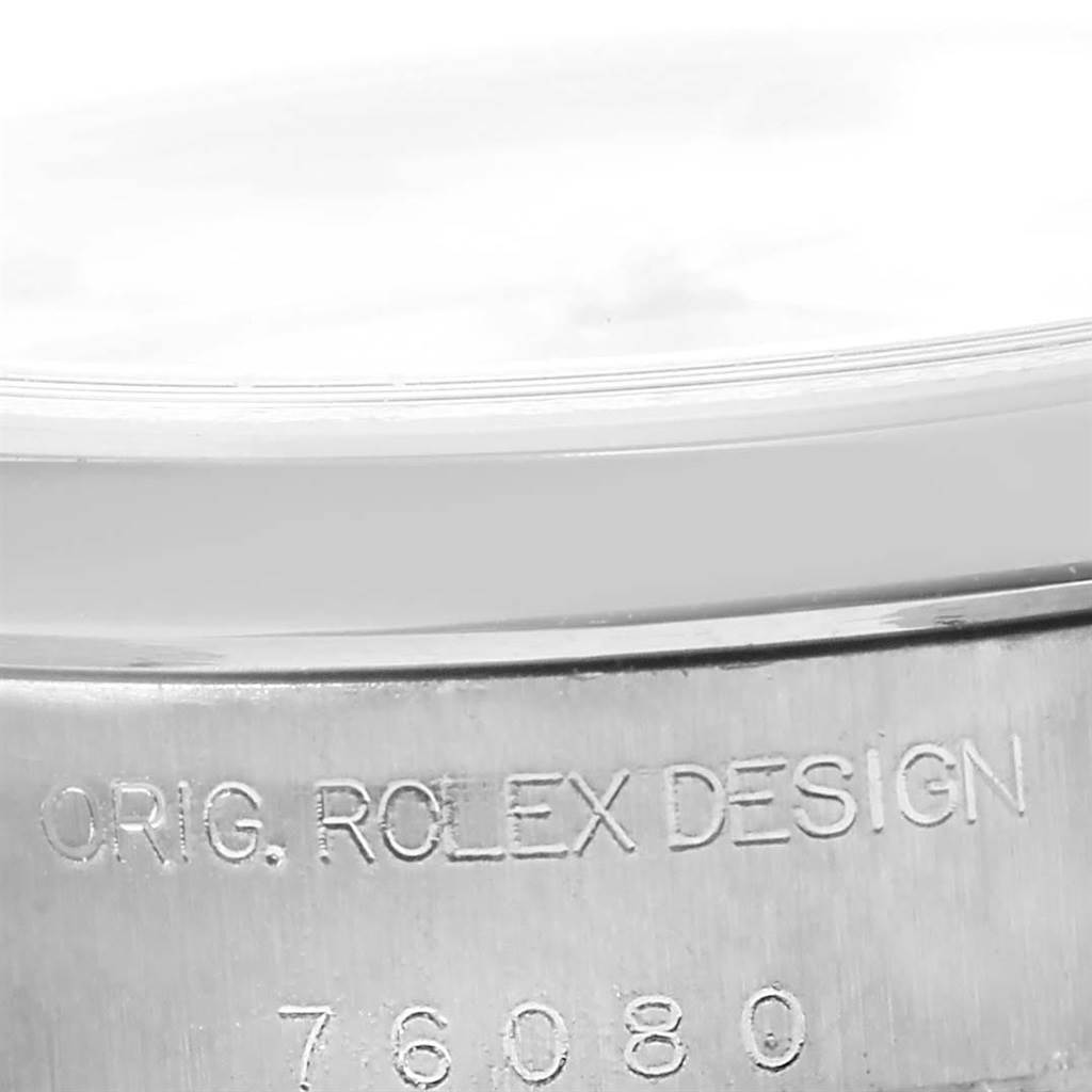 This close-up image shows the edge and engraved text on the case back of a Rolex Oyster Perpetual 76080 Women's Stainless Steel White Dial 76080 Women's Stainless Steel White Dial watch.