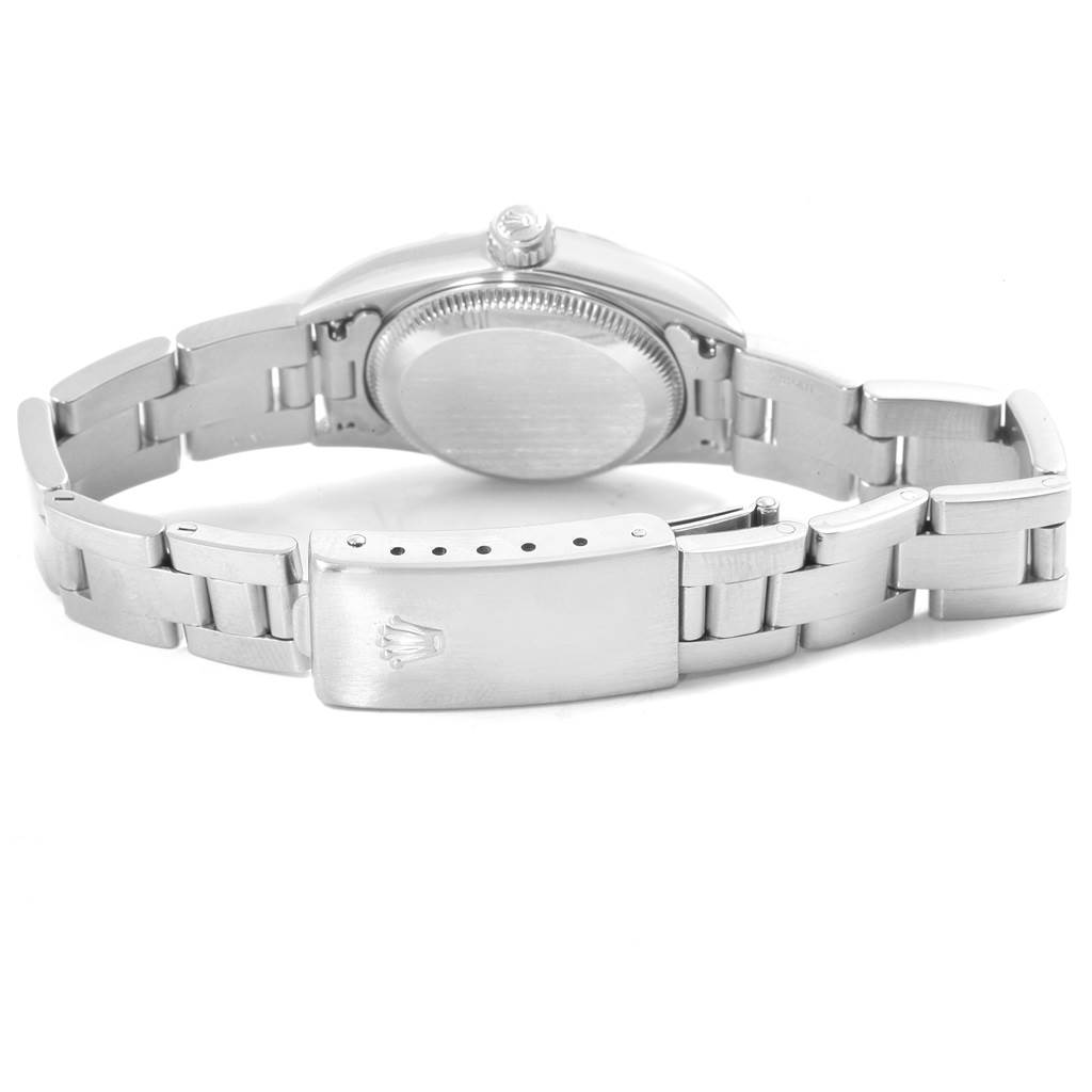 The image shows the case back, crown, and clasp of a Rolex Oyster Perpetual 76080 Women
s Stainless Steel Silver Dial 76080 Women
s Stainless Steel Silver Dial watch from a top-down angle.