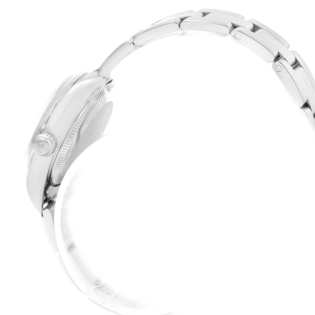 This image shows a side view of the Rolex Oyster Perpetual 76080 Women
s Stainless Steel Silver Dial 76080 Women
s Stainless Steel Silver Dial watch, focusing on the crown, bezel, and part of the bracelet.