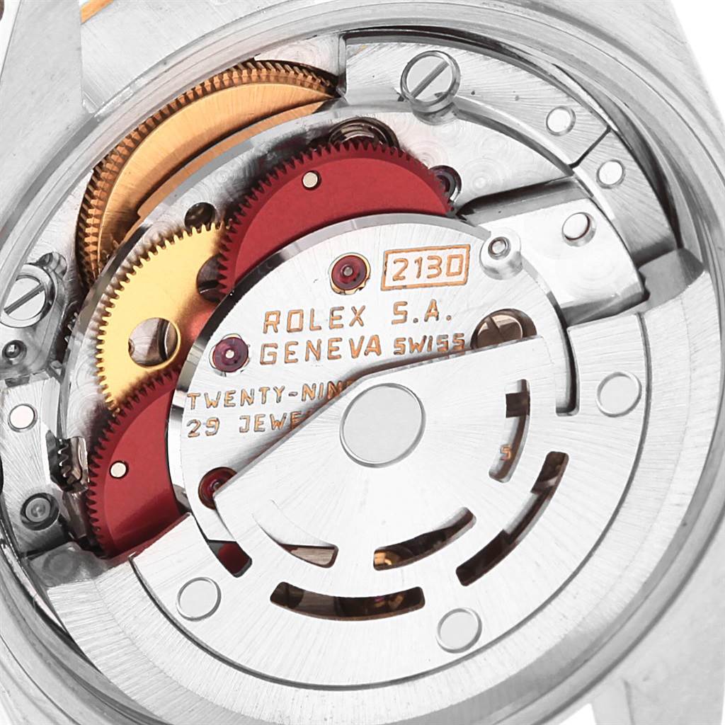 This close-up image shows the movement and internal components of a Rolex Oyster Perpetual 67193 Women
s Steel and Gold (two tone) White Dial 67193 Women
s Steel and Gold (two tone) White Dial watch, including gears and the rotor.