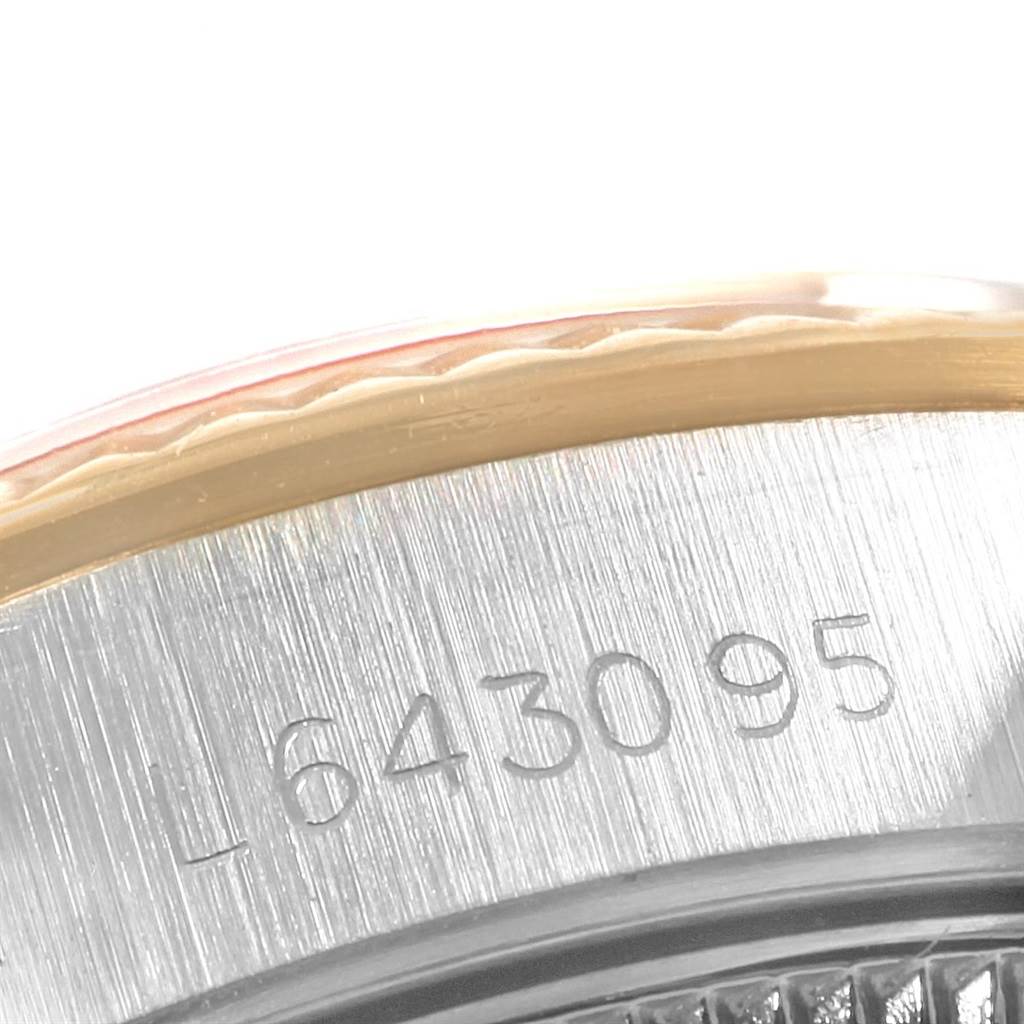 The image shows a close-up angle of the serial number engraved on the case side of a Rolex Oyster Perpetual 67193 Women
s Steel and Gold (two tone) White Dial 67193 Women
s Steel and Gold (two tone) White Dial watch.