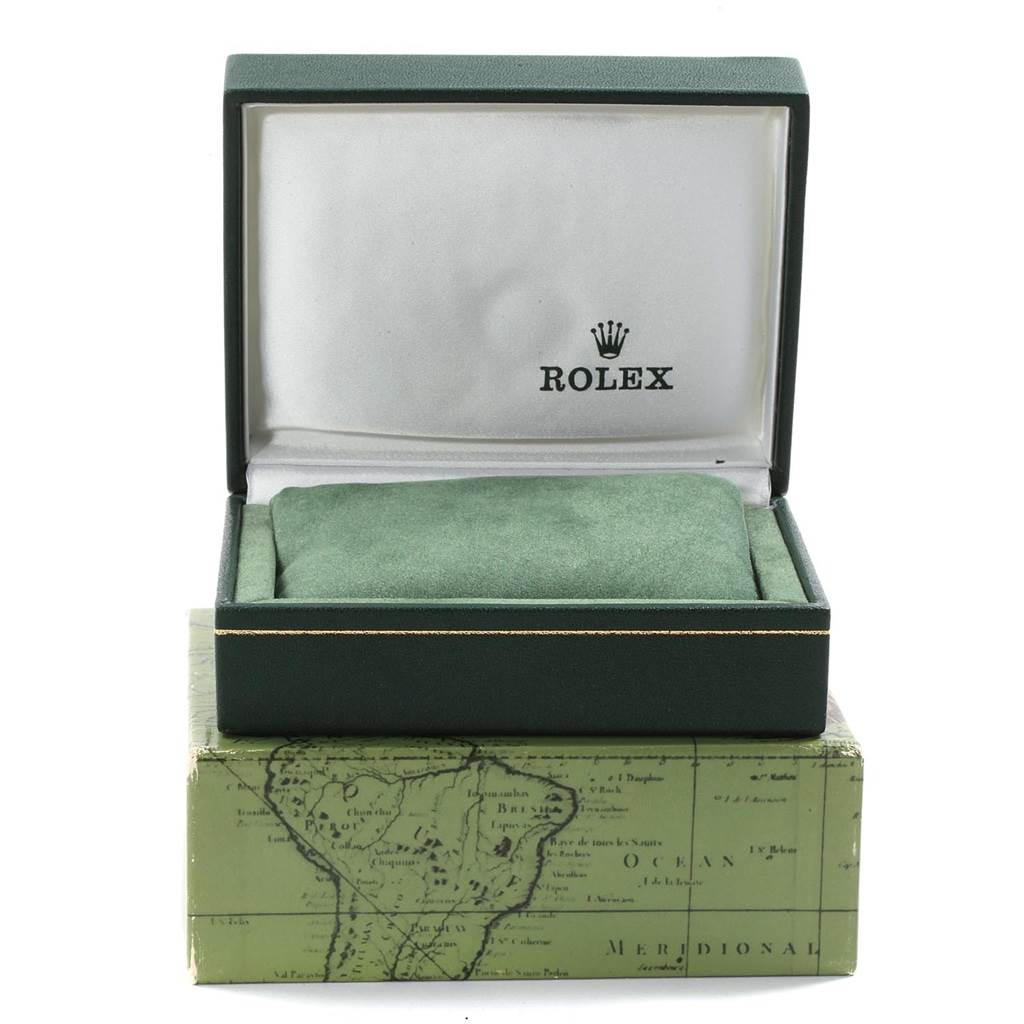 The image shows an empty green Rolex box for the Oyster Perpetual model, with a green cushion inside and the Rolex logo on the interior lid.