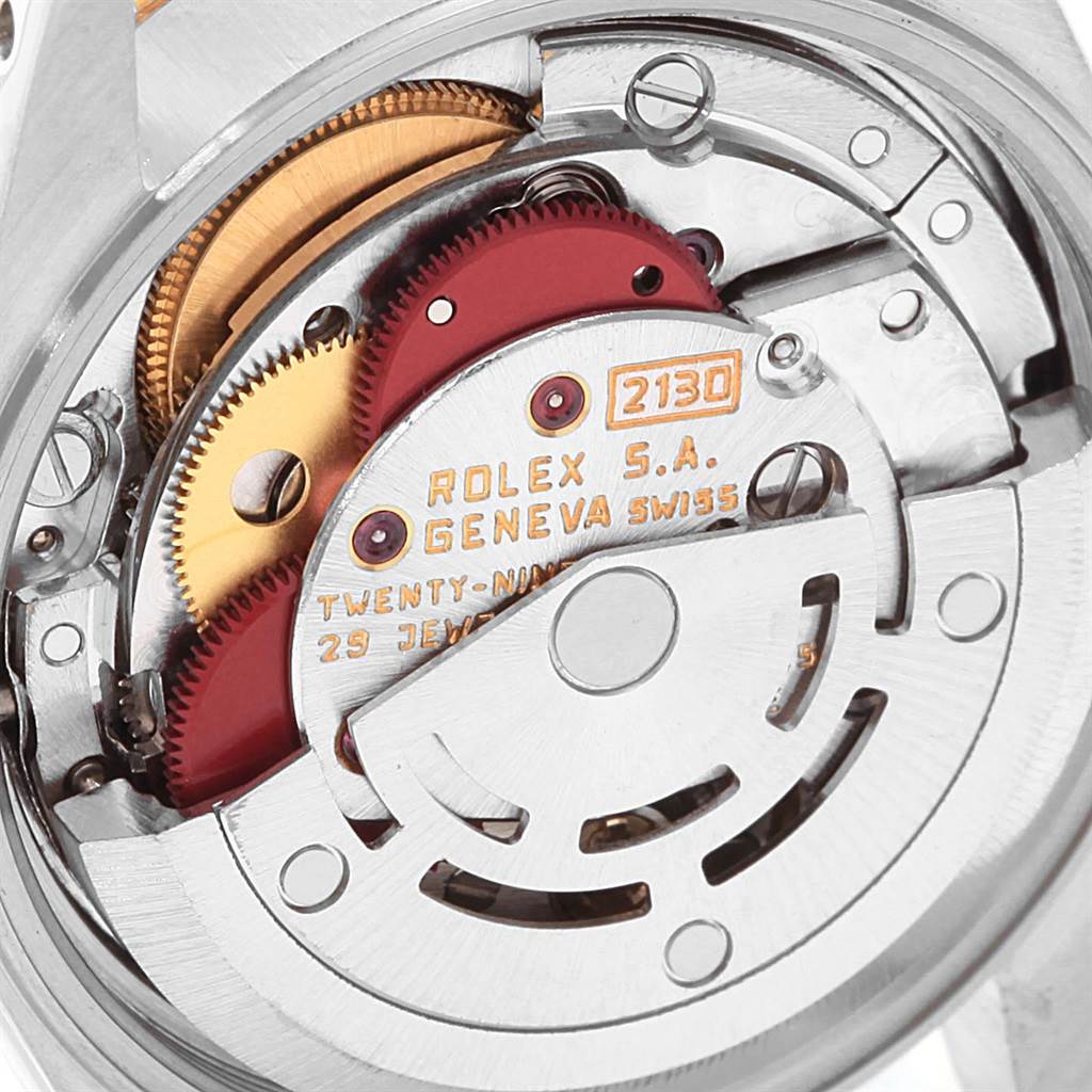 This image shows the intricate internal mechanism of the Rolex Oyster Perpetual 67193 Women
s Steel and Gold (two tone) White Dial 67193 Women
s Steel and Gold (two tone) White Dial watch, including gears and the rotor.
