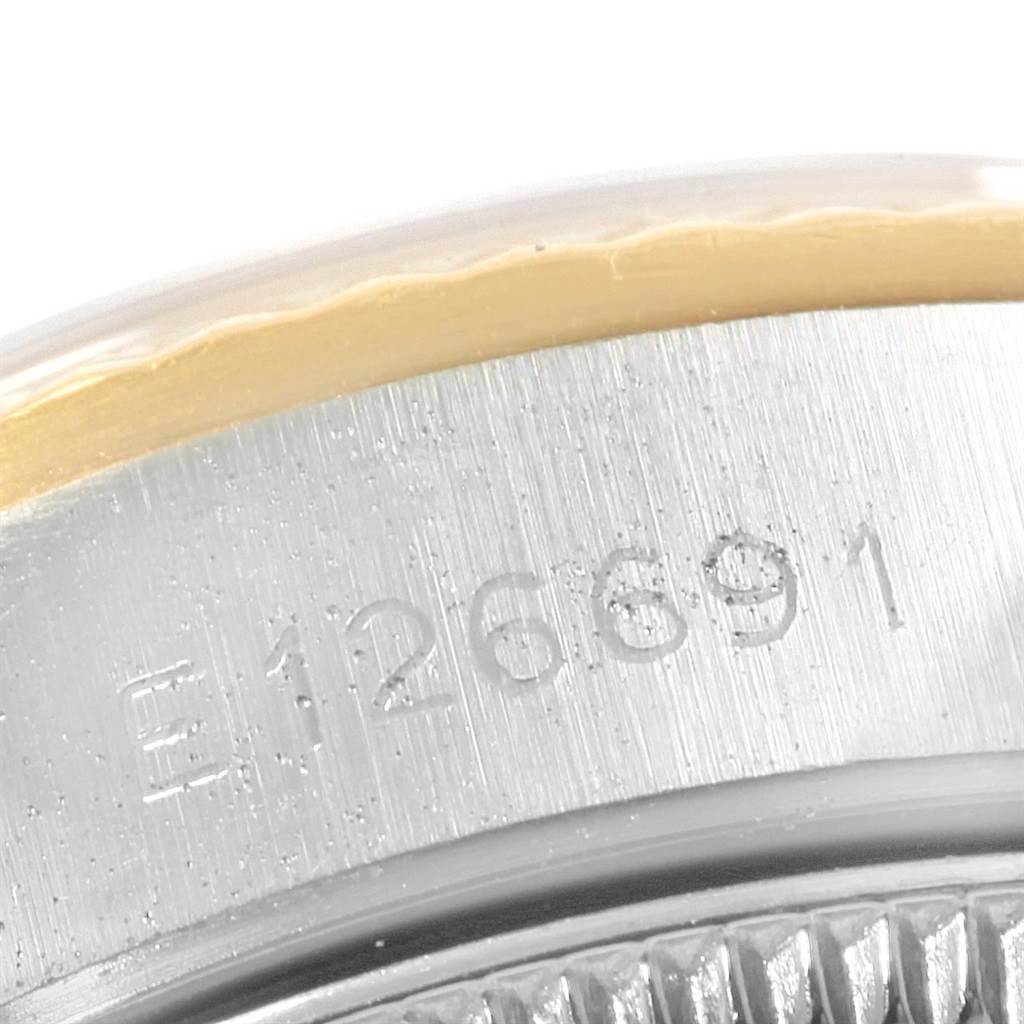 This image shows a close-up of the serial number engraving on the side of a Rolex Oyster Perpetual 67193 Women
s Steel and Gold (two tone) White Dial 67193 Women
s Steel and Gold (two tone) White Dial watch case.