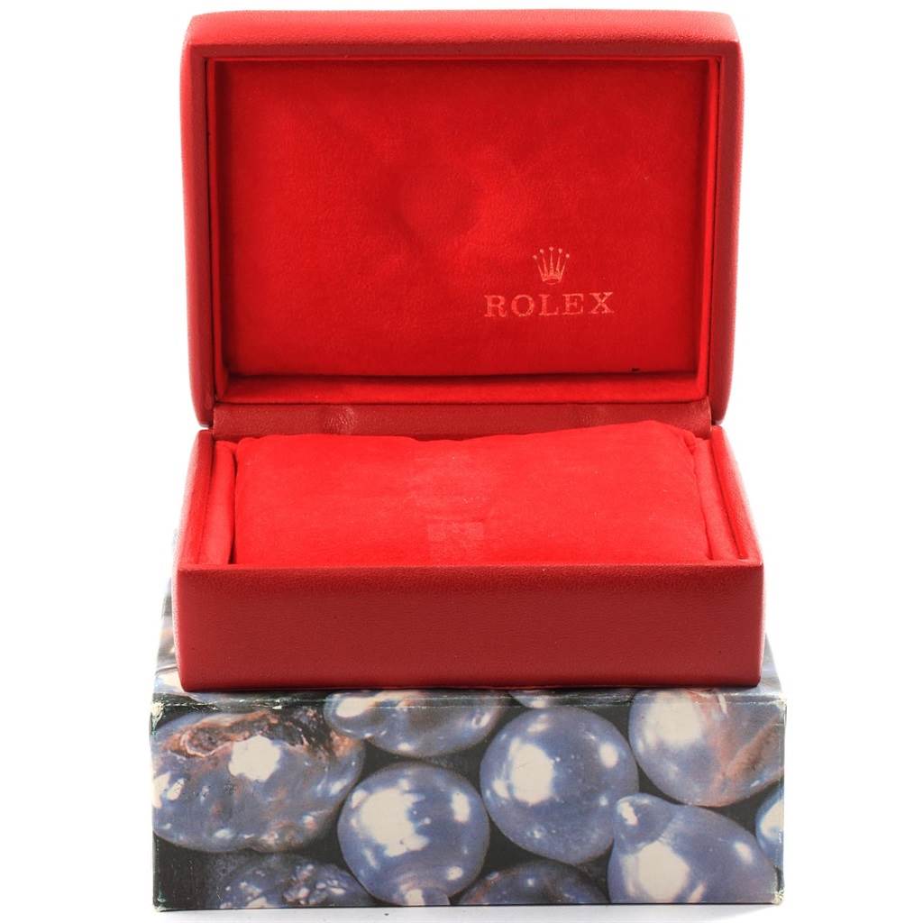 The image shows a red Rolex Oyster Perpetual 67193 Women
s Steel and Gold (two tone) White Dial 67193 Women
s Steel and Gold (two tone) White Dial watch box, open and empty, with the brand name inside the lid.