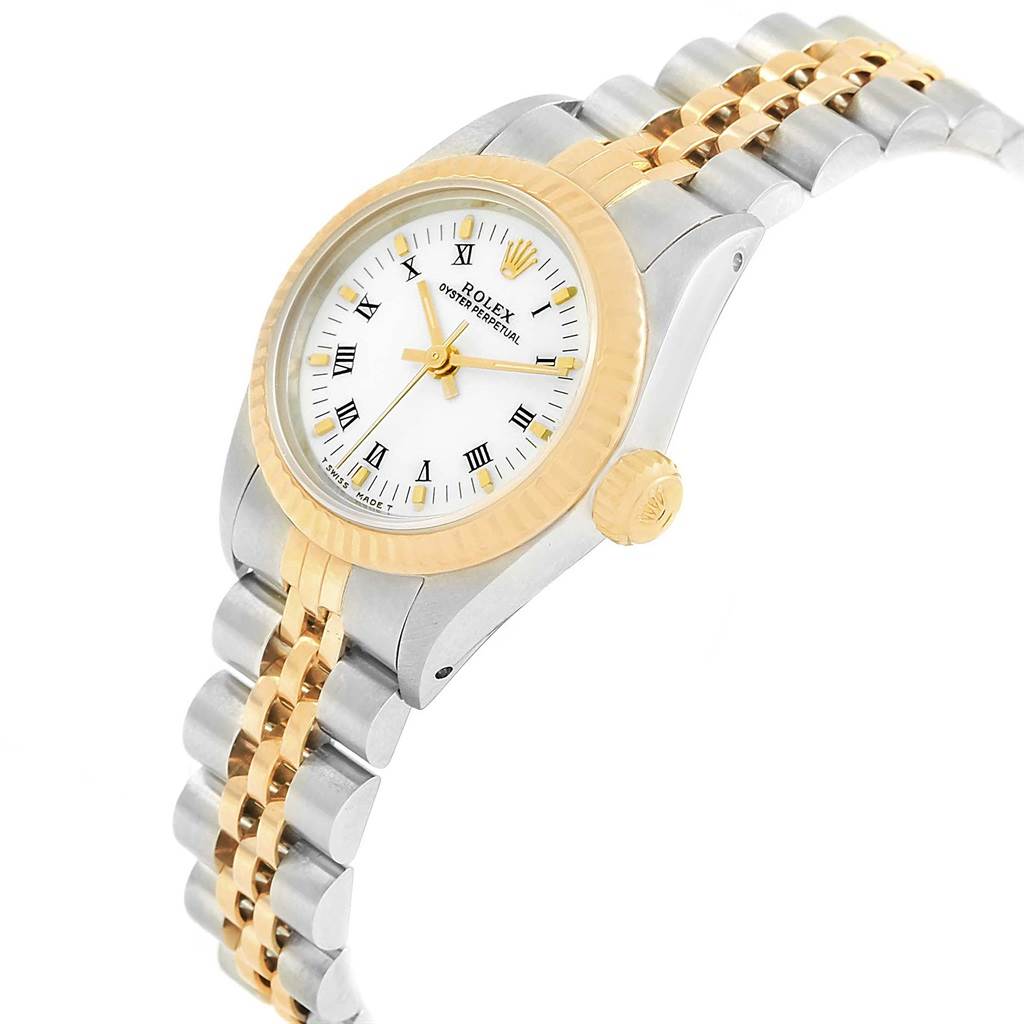 The image shows a close-up side angle of a Rolex Oyster Perpetual 67193 Women
s Steel and Gold (two tone) White Dial 67193 Women
s Steel and Gold (two tone) White Dial watch, highlighting its bezel, dial, crown, and two-tone bracelet.