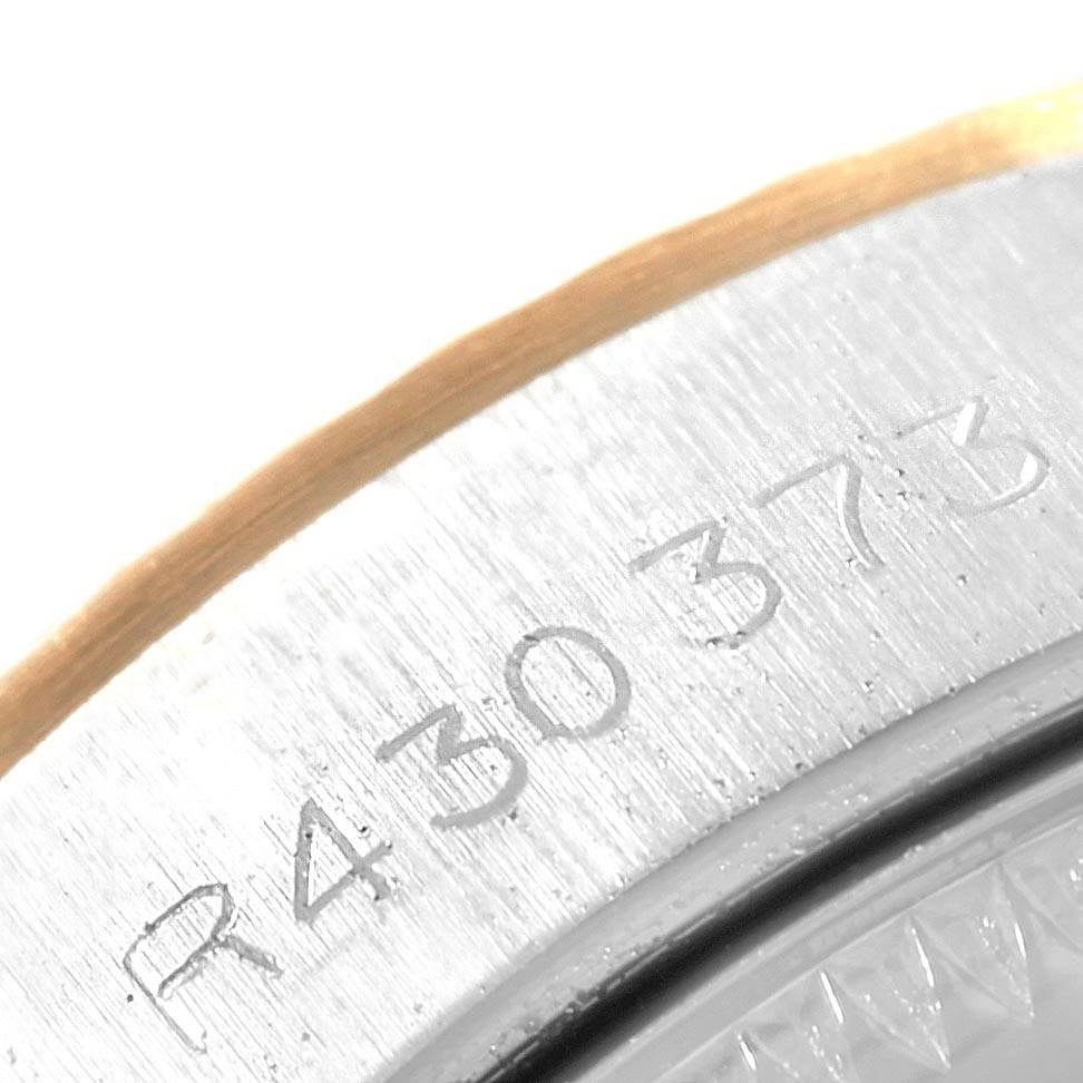 This close-up image shows the engraved serial number on the metal case back edge of a Rolex Oyster Perpetual 67193 Women
s Steel and Gold (two tone) White Dial 67193 Women
s Steel and Gold (two tone) White Dial watch.