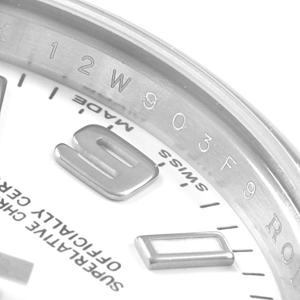 The image shows part of the dial and bezel of a Rolex Oyster Perpetual 176200 Women
s Stainless Steel White Dial 176200 Women
s Stainless Steel White Dial watch from an angled close-up view.
