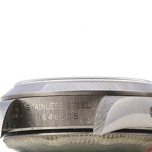 This image shows a side view of the stainless steel case of a Rolex Oyster Perpetual 67180 Women's Stainless Steel Black Dial 67180 Women's Stainless Steel Black Dial watch, displaying its serial number.