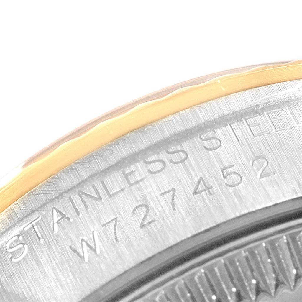 The image shows a close-up angle of the case back of a Rolex Oyster Perpetual 67193 Women's Steel and Gold (two tone) Grey Dial 67193 Women's Steel and Gold (two tone) Grey Dial watch, displaying part of its serial number and "Stainless Steel" text.
